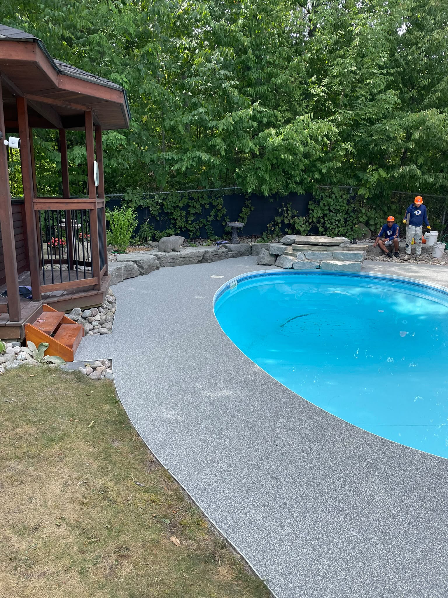 Grey rubber pool-deck surfacing installed at a Barrie home