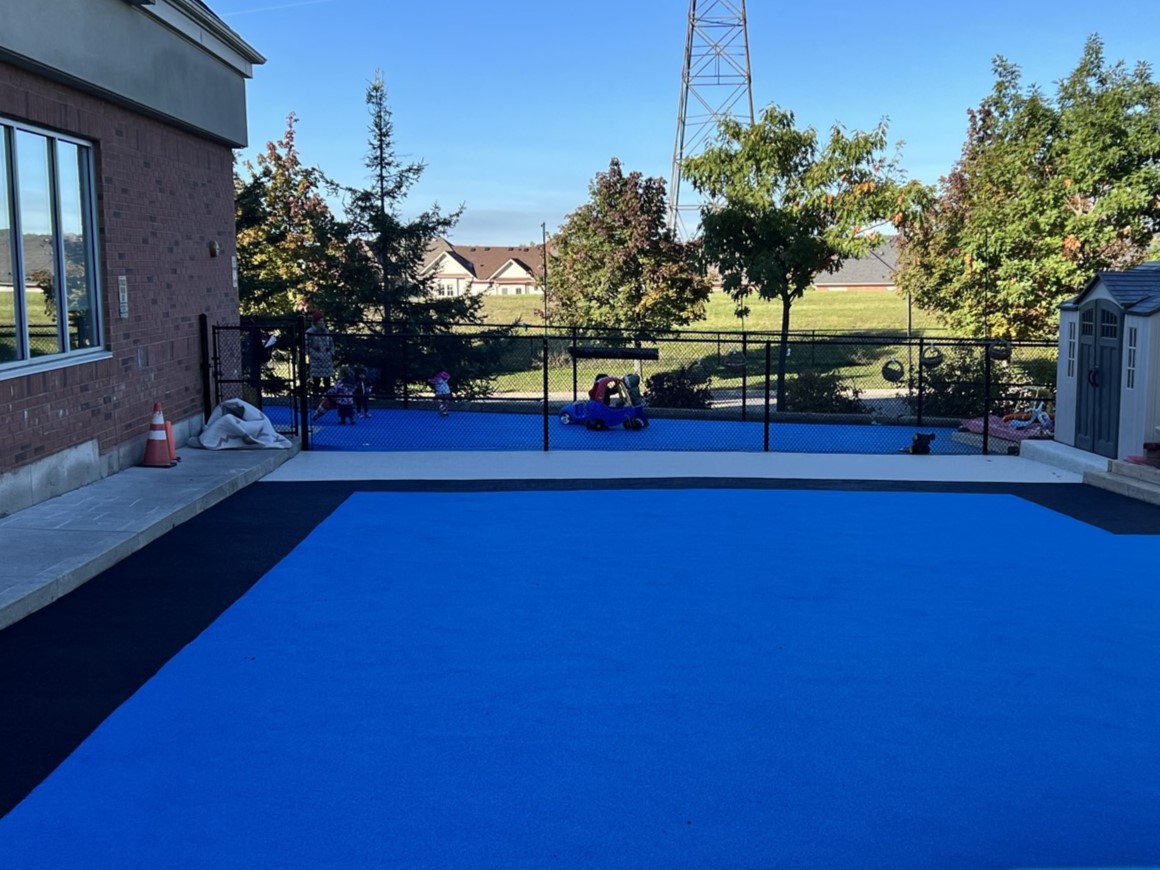 Blue and black rubber playground surfacing at Preschool Canada Aurora Campus